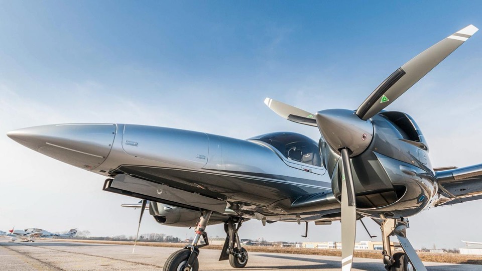 Nacelle moteur et hélice tripale d'un Diamond DA42-VI gris, vue en contre-plongée